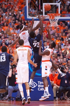 Syracuse forwards CJ Fair (5) and Rakeem Christmas (32) contest Villanova forward Daniel Ochefu's (23) shot.