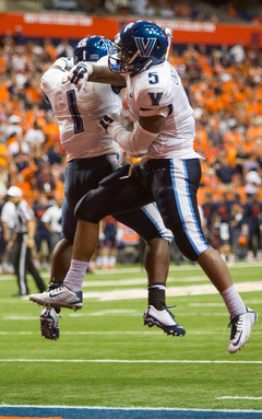 The Wildcats' Austin Medley (1) and Gary Underwood (5) celebrate after Underwood scored a touchdown in the second overtime.