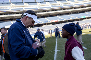 Doug Marrone signs an autograph at a 