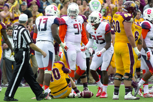 Ron Thompson, Isaiah Johnson and Dyshawn Davis celebrate a sack against Central Michigan in Syracuse's 40-3 win last Saturday in Mount Pleasant.