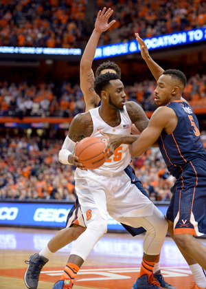 Syracuse senior Rakeem Christmas is hounded by a pair of Virginia defenders during SU's senior day loss Monday night.