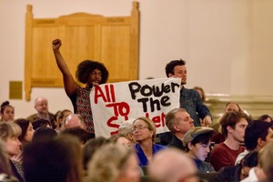 Members of Recognize Us, a student-led movement, silently held signs during a town hall on Wednesday.