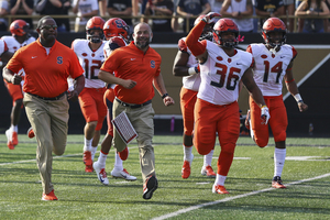 Chris Elmore leads SU out of the tunnel.