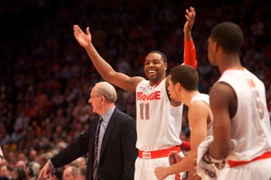 Syracuse guard Scoop Jardine celebrates from the sideline. Syracuse defeated Connecticut 58-55 in the quarterfinals of the Big East tournament at Madison Square Garden in New York on Thursday, March 8, 2012.