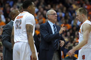 Syracuse head coach Jim Boeheim speaks to guard Trevor Cooney.