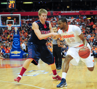 Syracuse forward James Southerland runs past Detroit's Evan Bruinsma.