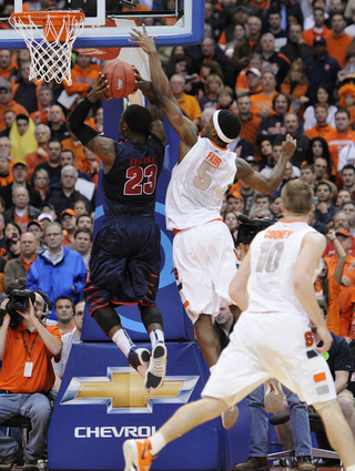 Syracuse forward C.J. Fair attempts to block a shot on Detroit's Doug Anderson.