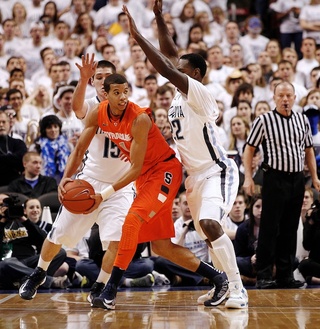 Syracuse guard Michael Carter-Williams (1) is trapped by Villanova guard Ryan Arcidiacono (15) and Villanova forward JayVaughn Pinkston (22) in the first half. 