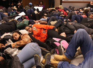 Jahnessa Payne, a freshman bioengineering major, joins other protesters in a 