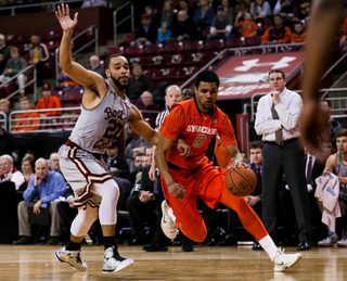 Gbinije tries to turn the corner and get to the basket while BC forward Aaron Brown tries to keep up with him.