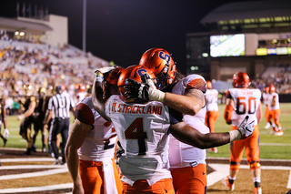 Syracuse center Airon Servais and Strickland embrace after one of his two touchdowns. 