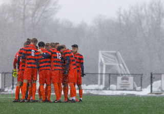 Syracuse huddles together.