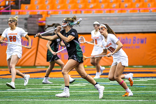 Loyola’s Emily Cooper shakes an SU defender to look for a pass.