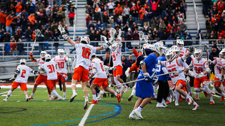 Syracuse's squad sprints onto the field after the game-winning goal. 